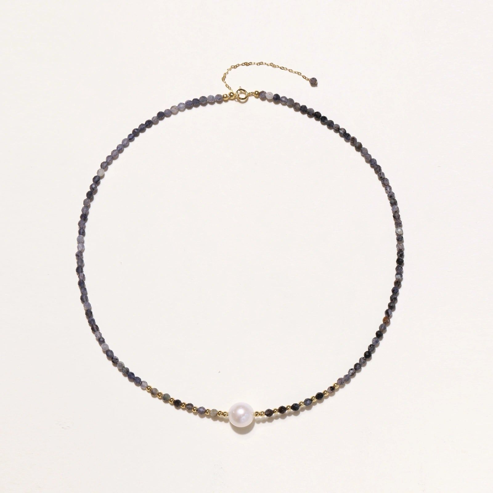 Dainty necklace with faceted purple iolite beads, gold vermeil accents, and central pink-white freshwater pearl.