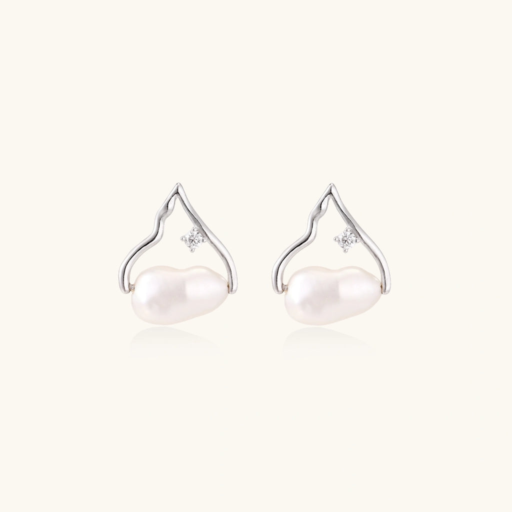 Silver mountain outline studs with baroque pearl and diamond accent on white background