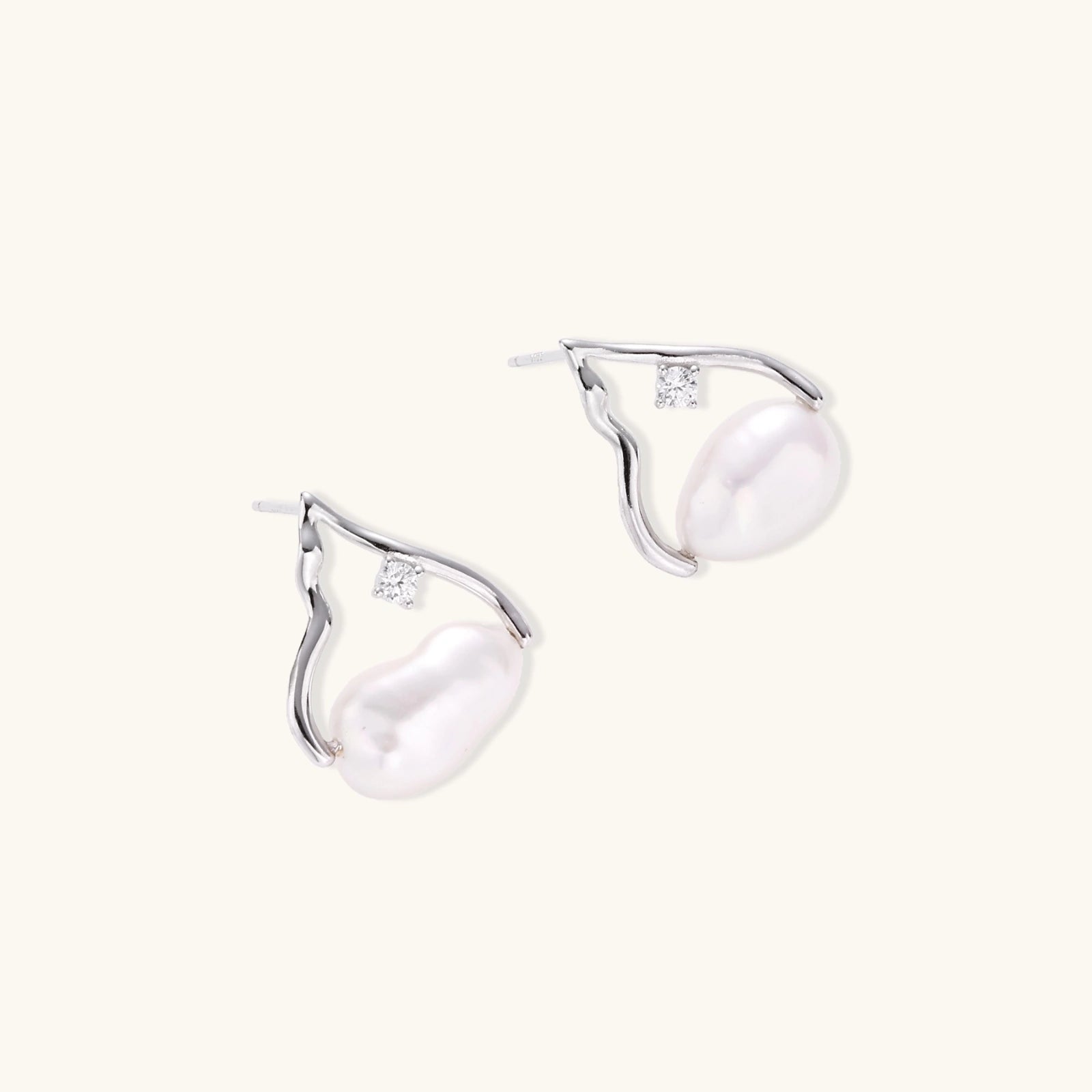 Silver mountain outline studs with baroque pearl and diamond accent on white background