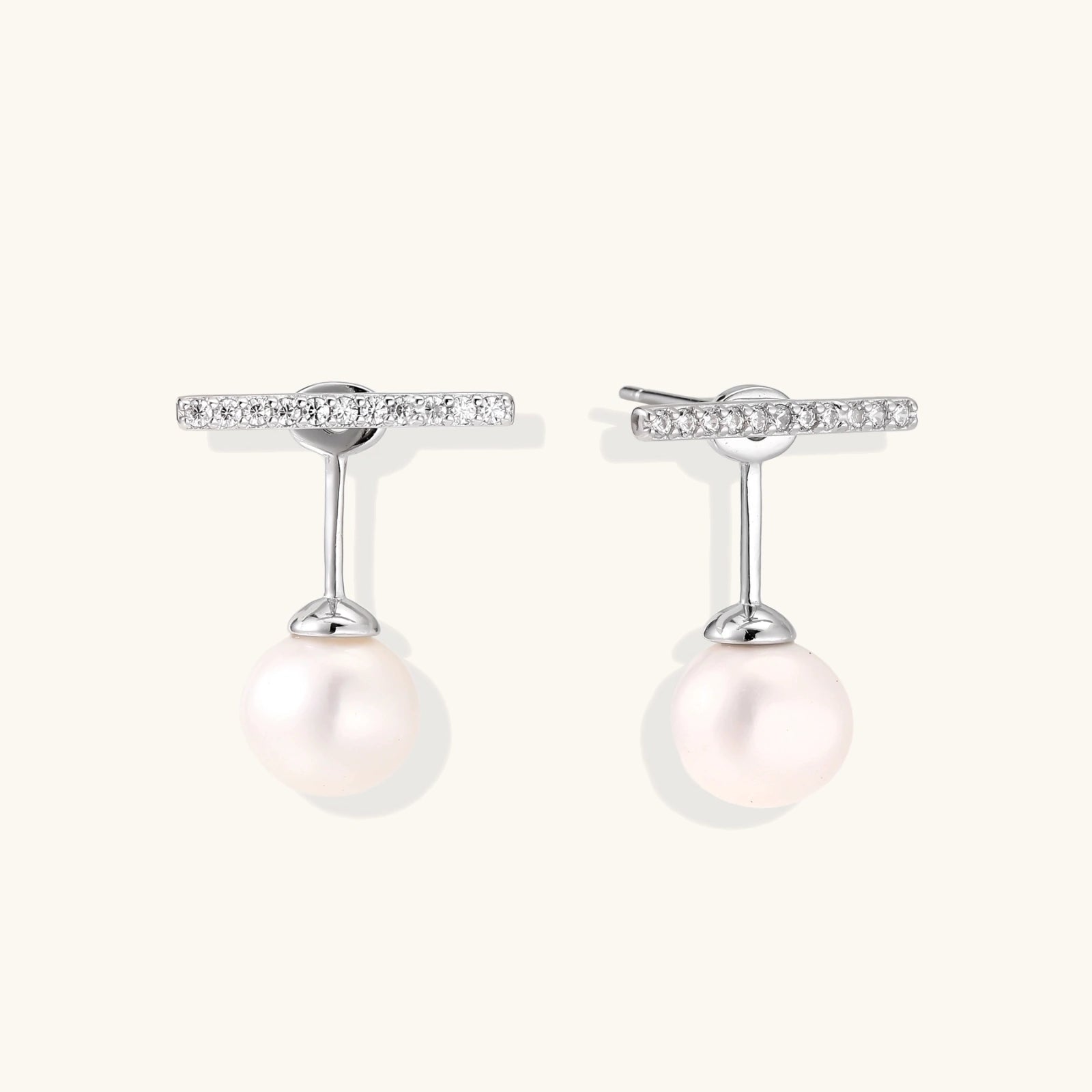 Rhodium-plated sterling silver ear jacket earrings with diamond-set horizontal bar and freshwater pearl drop