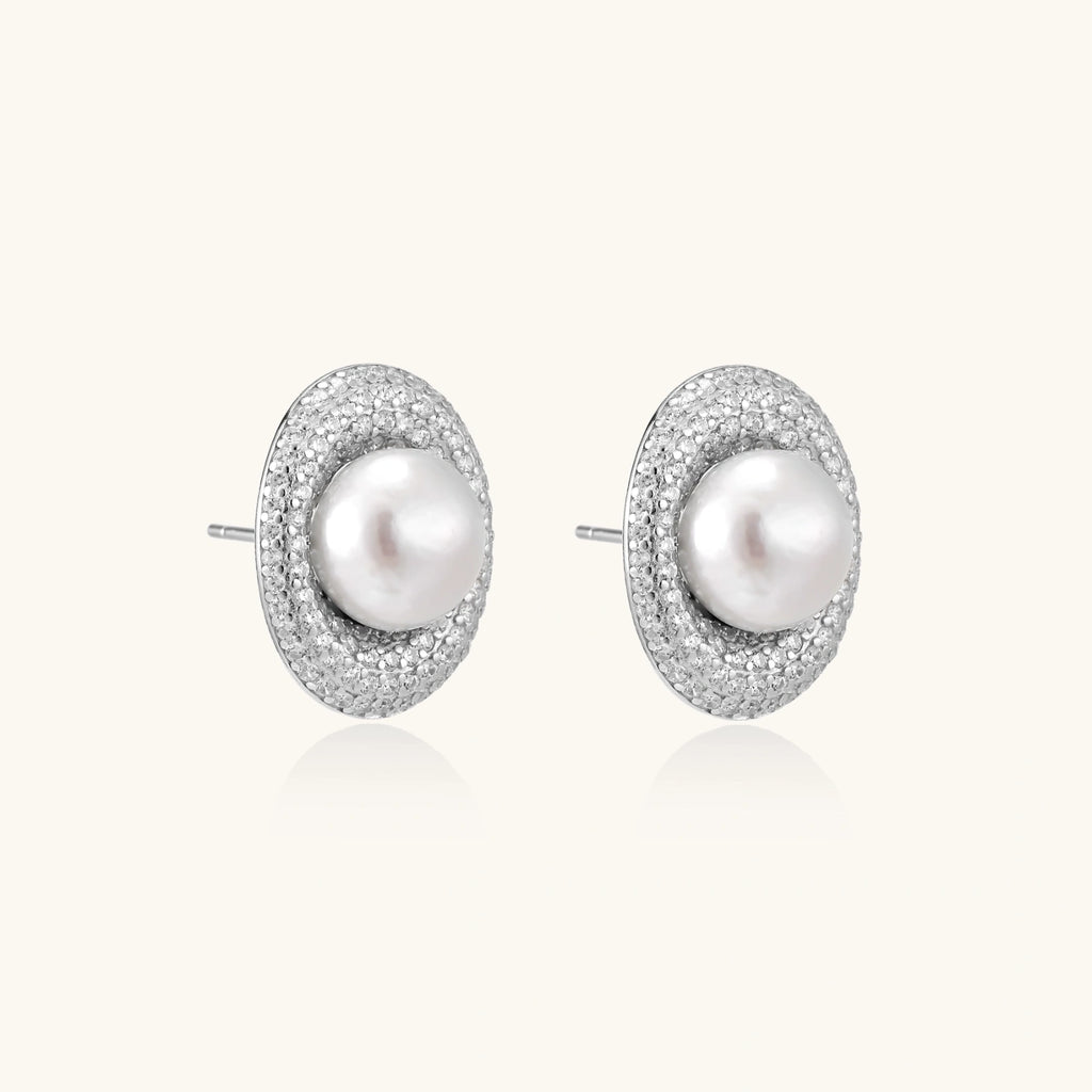 Elegant stud earrings with cream freshwater pearls surrounded by sparkly pavé crystals on rhodium-plated silver setting