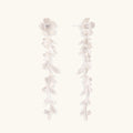Long sterling silver drop earrings with delicate floral vine design and crystal accents on white background