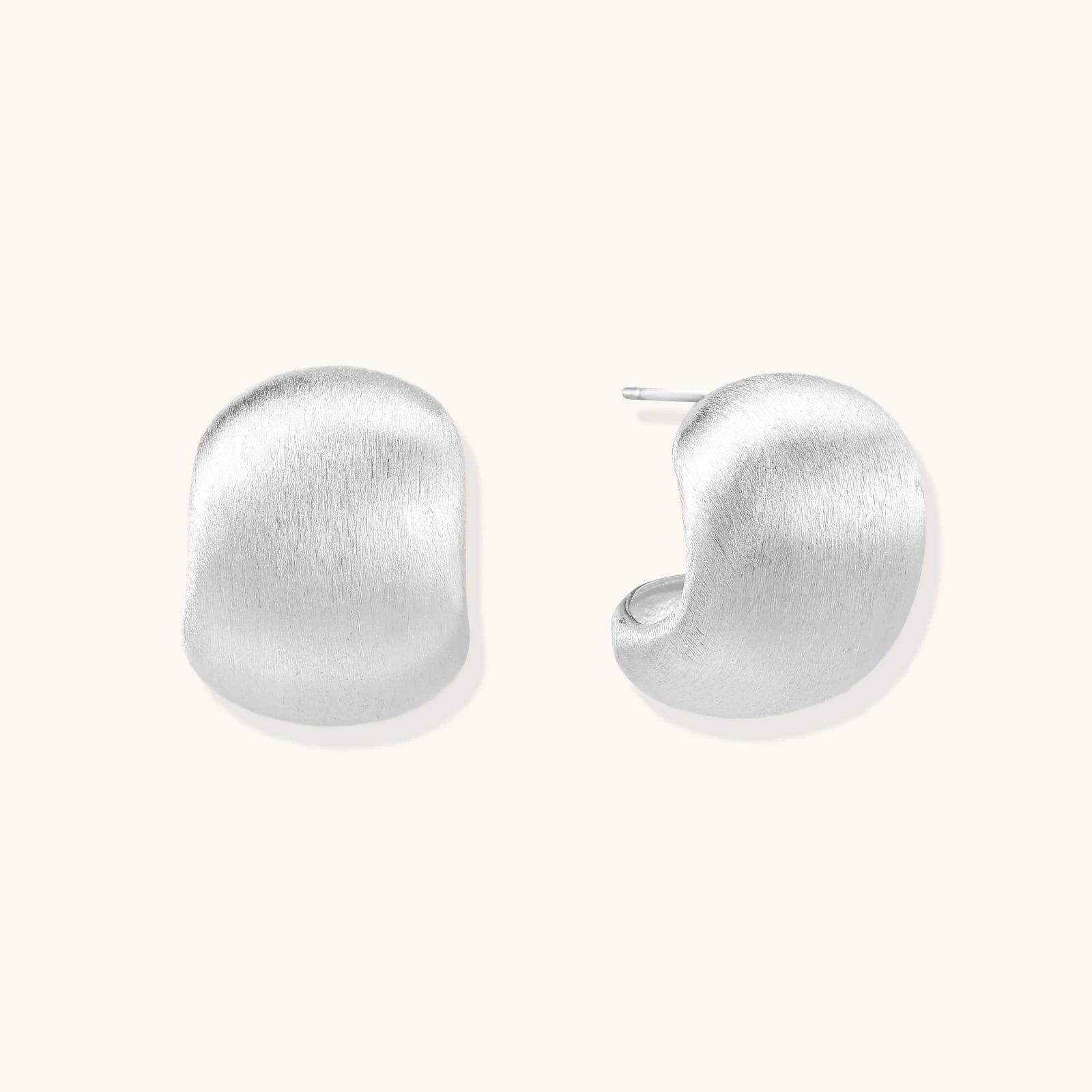 Brushed sterling silver cushion-shaped stud earrings with matte finish on white background