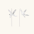 Delicate sterling silver dragonfly earrings with textured wings and curved threader hooks on white background