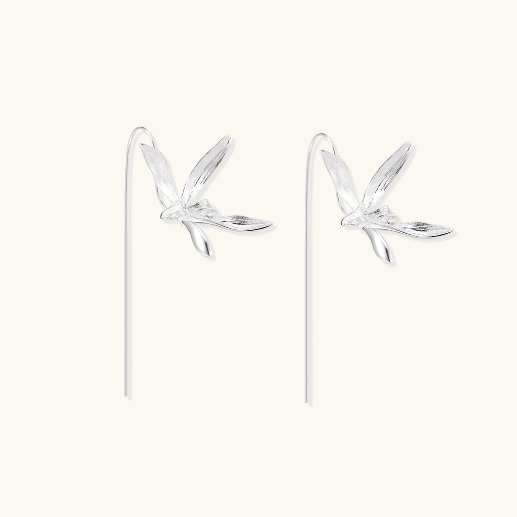 Delicate sterling silver dragonfly earrings with textured wings and curved threader hooks on white background