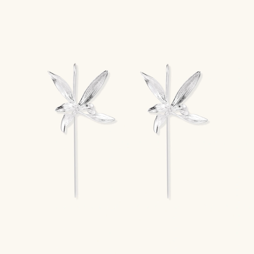 Delicate sterling silver dragonfly earrings with textured wings and curved threader hooks on white background