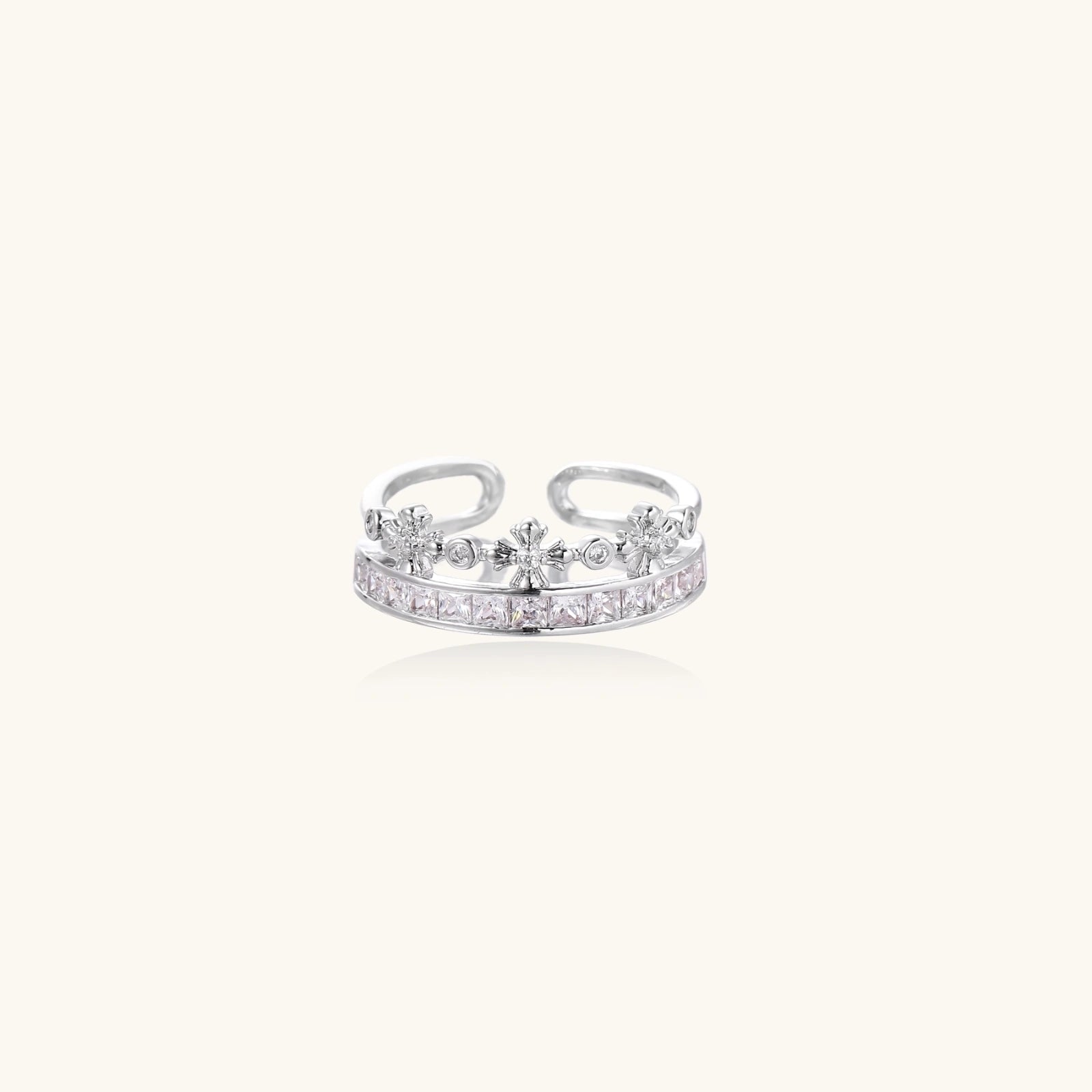 Silver-toned adjustable crown ring with channel-set square zirconia stones and delicate floral details on white background